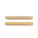 A pair of gold bar charms with clear gemstones used to the strap of Apple watch band, displayed on a clean white background. One bar is paved with small round Cubic Zirconia stones, and the other features four larger clear CZ stones set in a screw-head design.