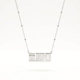 A silver necklace featuring a rectangular nameplate pendant with the Marwa in Kufi font style